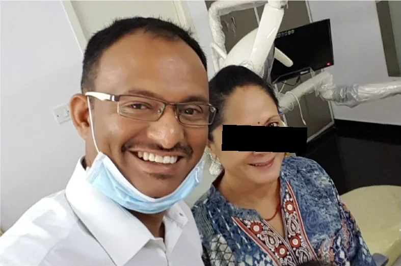 The patient with the dentist in the clinic after her treatment